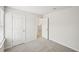 An Empty room with plush carpeting and neutral walls, featuring doorways leading to other rooms at 602 Wallace Oak Ln, Lawrenceville, GA 30045