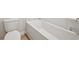 Bright bathroom featuring a toilet and a modern bathtub, providing a clean and comfortable space at 1260 Firefly Field Trce Trce, Lawrenceville, GA 30045