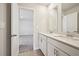 Modern bathroom with double sinks, a large mirror, and a doorway leading to a carpeted room at 1260 Firefly Field Trce Trce, Lawrenceville, GA 30045