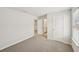 Bedroom with neutral carpet and a window providing natural light, with doorways for convenience at 1260 Firefly Field Trce Trce, Lawrenceville, GA 30045