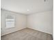 Bedroom with neutral carpet and a window providing natural light, creating a bright and inviting space at 1260 Firefly Field Trce Trce, Lawrenceville, GA 30045