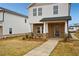 Inviting two-story home with stone accents, covered entrance, and concrete walkway to the front door at 1260 Firefly Field Trce Trce, Lawrenceville, GA 30045