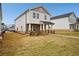 Inviting two-story house featuring stone detailing, a covered porch, and a concrete sidewalk at 1260 Firefly Field Trce Trce, Lawrenceville, GA 30045