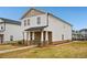 Attractive two-story house featuring stone detailing, a covered porch, and a concrete sidewalk at 1260 Firefly Field Trce Trce, Lawrenceville, GA 30045