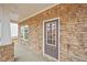 Close up of a stone porch with a gray front door and white trim, offering a welcoming entrance at 1260 Firefly Field Trce Trce, Lawrenceville, GA 30045