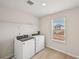 Bright laundry room featuring a new washer and dryer and a window bringing in natural light at 1260 Firefly Field Trce Trce, Lawrenceville, GA 30045