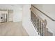 Open-concept living area with hardwood floors and staircase, adjacent to the modern kitchen at 1260 Firefly Field Trce Trce, Lawrenceville, GA 30045