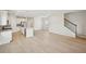 Expansive living space featuring hardwood floors, and leading to a modern kitchen with a center island at 1260 Firefly Field Trce Trce, Lawrenceville, GA 30045