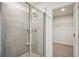 Glass shower stall with neutral toned tiled walls and floors featuring a modern shower head at 1260 Firefly Field Trce Trce, Lawrenceville, GA 30045