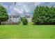 Large grassy backyard with mature trees and privacy fence at 142 Benfield Cir, Cartersville, GA 30121