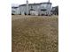 Large backyard with brown grass and home view at 142 Benfield Cir, Cartersville, GA 30121