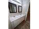 Bathroom with double sinks, marble countertop, and updated light fixtures at 142 Benfield Cir, Cartersville, GA 30121