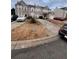 Two-story townhome with attached garage and small yard at 142 Benfield Cir, Cartersville, GA 30121