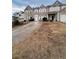 Two-story townhome with a driveway and landscaped yard at 142 Benfield Cir, Cartersville, GA 30121