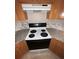 White stove and granite countertops in this well-lit kitchen at 142 Benfield Cir, Cartersville, GA 30121