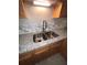 Modern double kitchen sink with granite countertop and tile backsplash at 142 Benfield Cir, Cartersville, GA 30121