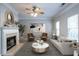 Spacious living room with fireplace, comfy seating, and large windows at 142 Benfield Cir, Cartersville, GA 30121