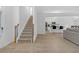 Open concept entryway with stairs, hardwood floors and views into the living room and kitchen at 180 Eryn Ter, Covington, GA 30014