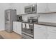 Modern kitchen with stainless steel appliances and white cabinets at 180 Eryn Ter, Covington, GA 30014
