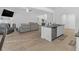 Open concept kitchen with island, stainless steel appliances, and hardwood floors at 180 Eryn Ter, Covington, GA 30014