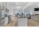 Open concept kitchen with island, stainless steel appliances, and hardwood floors at 180 Eryn Ter, Covington, GA 30014