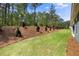 Large backyard with a landscaped slope and views of mature trees at 48 Easton Park Blvd, Dallas, GA 30157