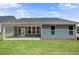 Newly built home showcasing a covered patio and a spacious backyard with green grass at 48 Easton Park Blvd, Dallas, GA 30157