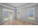 Dining room featuring a set of french doors, two windows, and hardwood floors at 48 Easton Park Blvd, Dallas, GA 30157