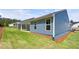 View of the back of the house with siding and covered patios, green grass, and landscaping at 48 Easton Park Blvd, Dallas, GA 30157