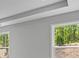 Bright room with crown molding and two windows that offer a glimpse of the outdoors at 48 Easton Park Blvd, Dallas, GA 30157