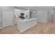 Well-lit kitchen with an island that has a sink and white countertops with a stainless steel microwave at 48 Easton Park Blvd, Dallas, GA 30157