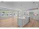 Open-concept kitchen featuring a central island, stainless steel appliances, and connection to a bright living area at 48 Easton Park Blvd, Dallas, GA 30157