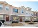 Three-unit townhome building with gray siding, stone accents, and charming front yards at 863 Ambient Sw Way, Atlanta, GA 30331