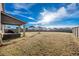 Large backyard with a covered patio and wooden privacy fence at 909 Teabiscuit Way, Mcdonough, GA 30253