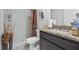 Clean bathroom with shower, granite countertop, and brown vanity at 909 Teabiscuit Way, Mcdonough, GA 30253