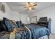 Spacious bedroom with a large bed, ceiling fan, and flat-screen TV at 909 Teabiscuit Way, Mcdonough, GA 30253