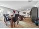 Open dining area with hardwood floors and a view into the living room at 909 Teabiscuit Way, Mcdonough, GA 30253