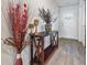 Bright entryway with decorative console table and hardwood floors at 909 Teabiscuit Way, Mcdonough, GA 30253
