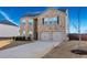 Two-story brick home with a two-car garage and landscaped yard at 909 Teabiscuit Way, Mcdonough, GA 30253
