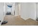 Upstairs hallway with carpet and access to bedrooms at 909 Teabiscuit Way, Mcdonough, GA 30253