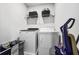 Convenient laundry room with washer, dryer, and shelving at 909 Teabiscuit Way, Mcdonough, GA 30253