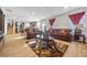 Spacious living room with hardwood floors, leather couches, and a view of the kitchen at 909 Teabiscuit Way, Mcdonough, GA 30253