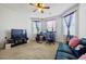 Bright home office space with a desk, chair, and comfortable couch at 909 Teabiscuit Way, Mcdonough, GA 30253