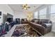 Comfortable sitting room featuring a brown leather sofa and a large TV at 909 Teabiscuit Way, Mcdonough, GA 30253