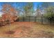 Fenced backyard with small tree and open space at 231 Magnaview Dr, Mcdonough, GA 30253