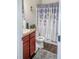 Clean bathroom with dark wood vanity, white toilet, and patterned shower curtain at 231 Magnaview Dr, Mcdonough, GA 30253