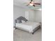Bright bedroom featuring a queen-size bed and a window with blinds at 231 Magnaview Dr, Mcdonough, GA 30253