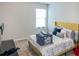 Second bedroom with a yellow bed frame and TV mount at 231 Magnaview Dr, Mcdonough, GA 30253