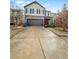 Two-story house with a brown brick and beige vinyl exterior, a two-car garage, and a concrete driveway at 231 Magnaview Dr, Mcdonough, GA 30253