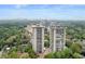 Stunning aerial view showcasing a complex surrounded by lush greenery and a distant cityscape at 2575 Peachtree Ne Rd # 11D, Atlanta, GA 30305